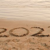 2023 written in the sand on the beach