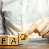 person placing wooden blocks with the word FAQ